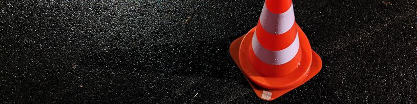 A red traffic cone on a road