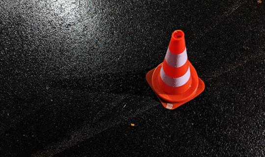 A red traffic cone on a road