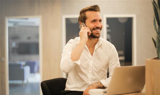 man in office on a mobile phone