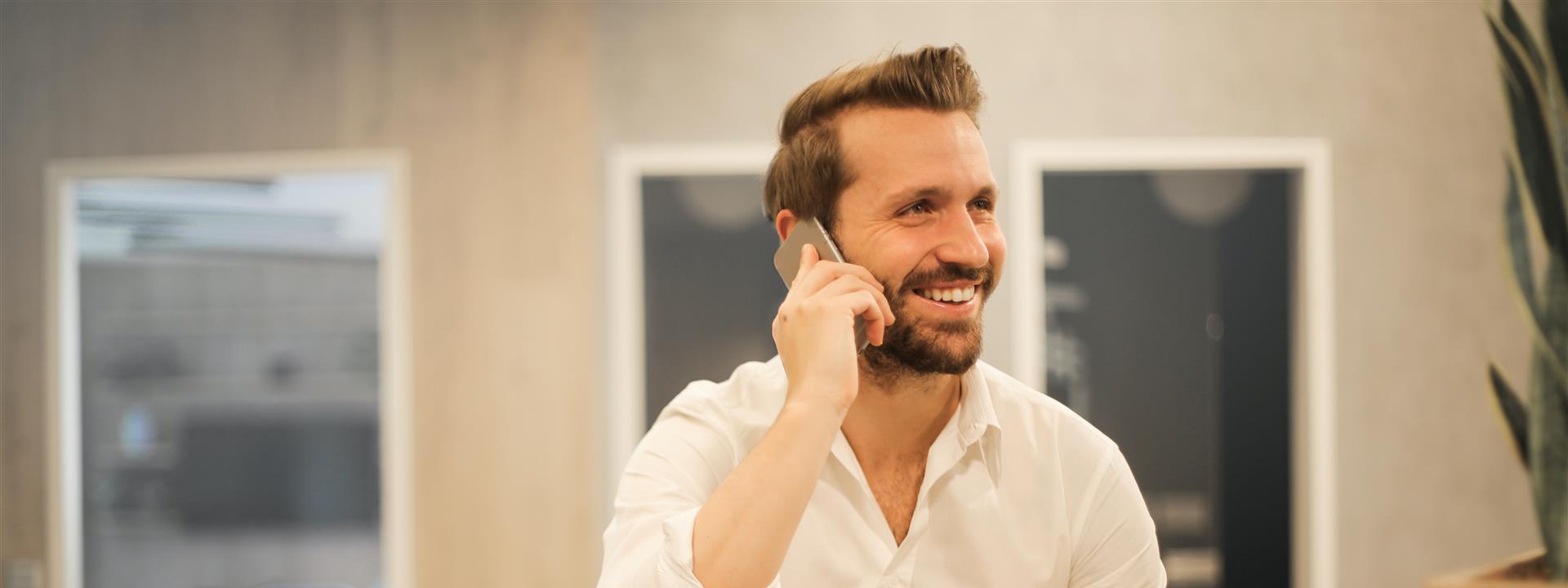 man in office on a mobile phone