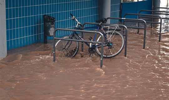 a bike outside a building in a flood