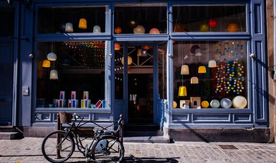 the outside of a high street shop with a bike outside