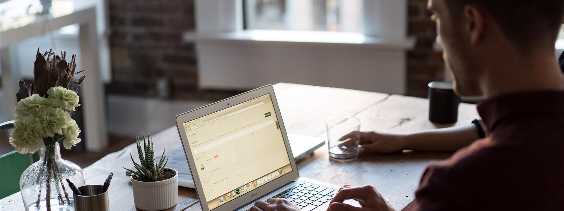 a man in a modern office working on a laptop