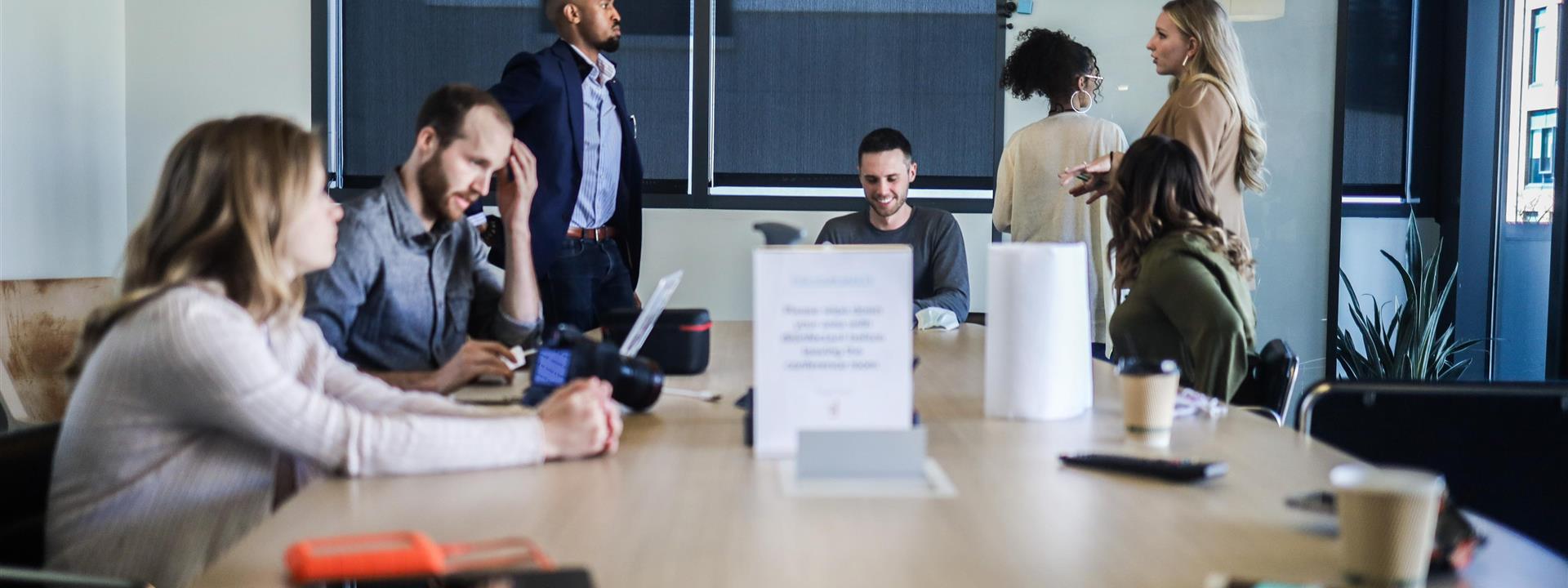 six office workers around a boardroom table