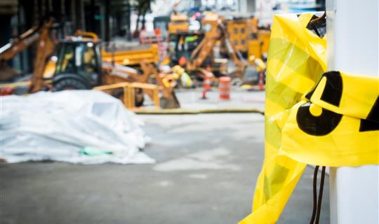 broken yellow tape outside a construction site