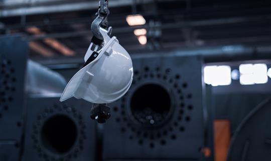 a white hard hat hanging on a wall