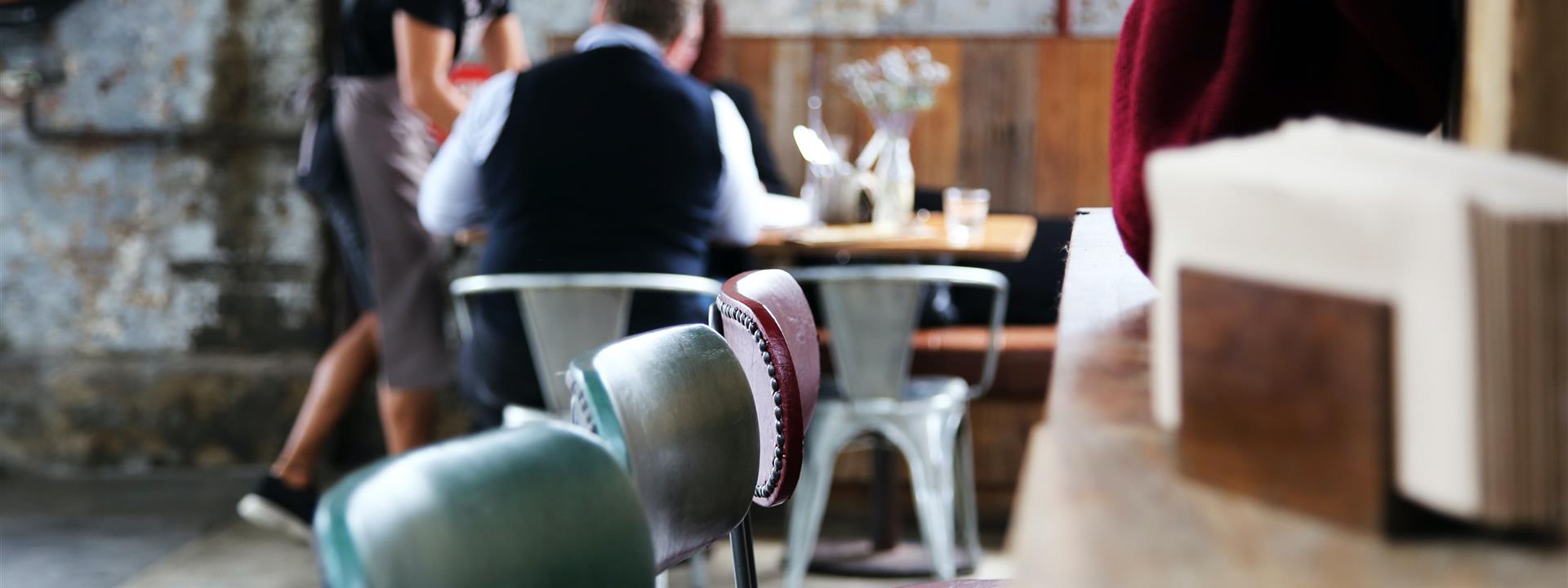 a restaurant with people at a table eating in the background