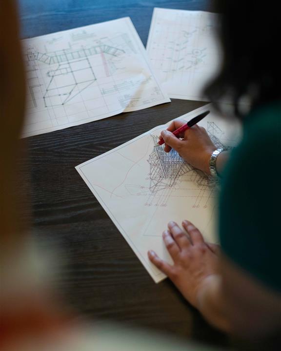 a woman drawing plans for a roof