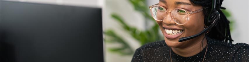 woman answering telephone using headset smiling