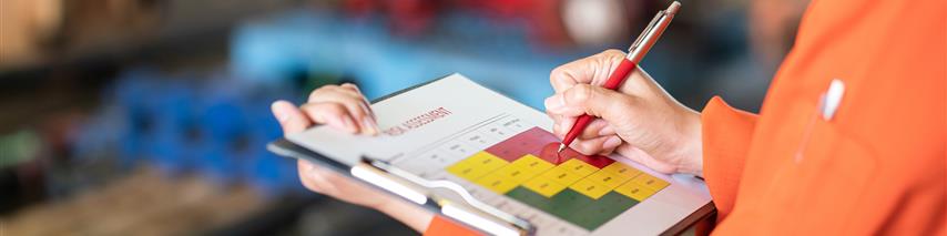 Person using risk management table to assess equipment