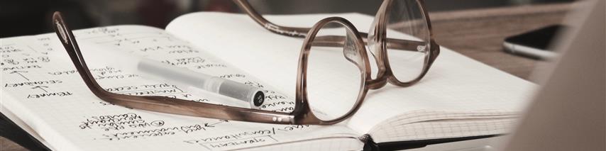 a pair of glasses on a notebook